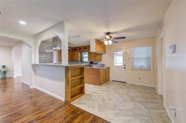 kitchen featuring stainless steel refrigerator, ceiling fan, kitchen peninsula, extractor fan, and light hardwood / wood-style floors