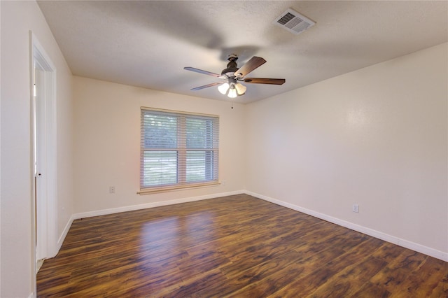 spare room with dark hardwood / wood-style floors and ceiling fan