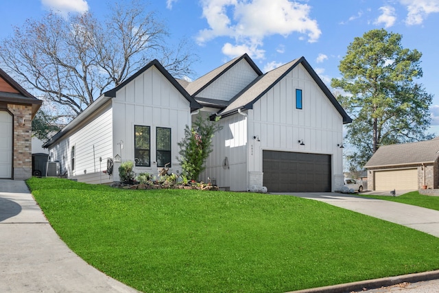 modern farmhouse style home featuring a front yard, a garage, and central air condition unit