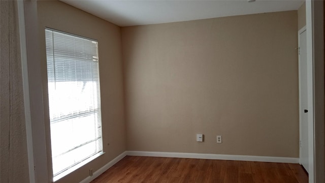 unfurnished room featuring hardwood / wood-style flooring