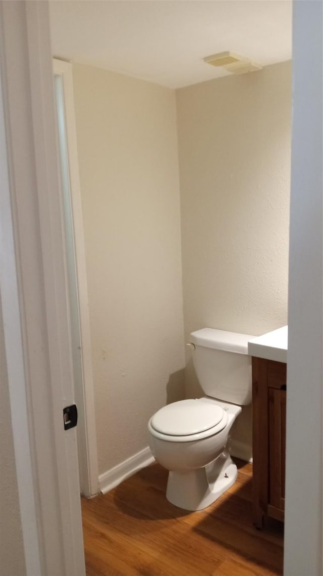 bathroom featuring hardwood / wood-style floors, vanity, and toilet