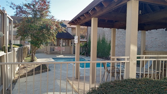 view of swimming pool featuring a gazebo and a patio area