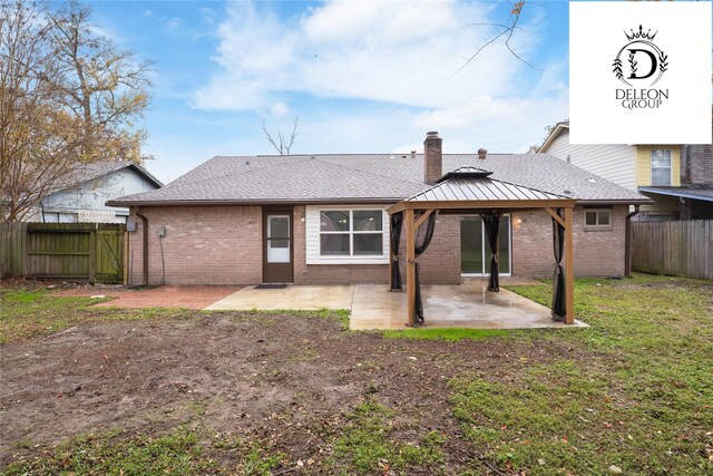 back of house with a gazebo and a patio area