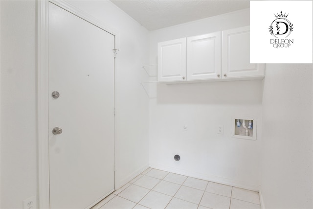 laundry room with electric dryer hookup, cabinets, light tile patterned floors, and hookup for a washing machine