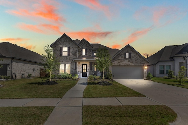 french provincial home featuring a garage and a lawn