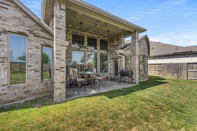 back of house with a patio area and a yard