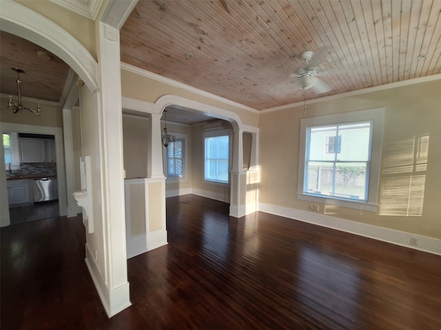 empty room featuring dark hardwood / wood-style floors, ceiling fan, wood ceiling, and ornamental molding