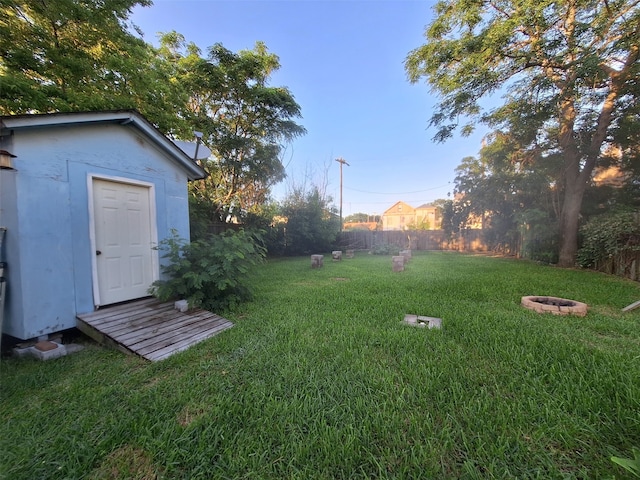 view of yard with an outdoor fire pit