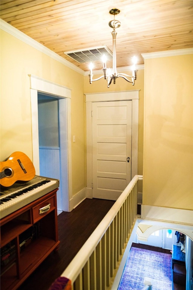 hall with crown molding, dark hardwood / wood-style flooring, wood ceiling, and an inviting chandelier