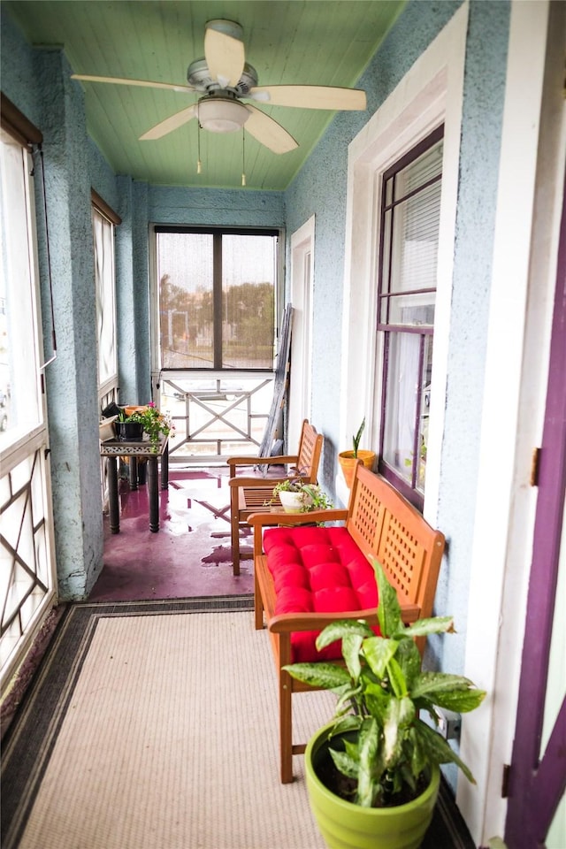 sunroom / solarium featuring ceiling fan