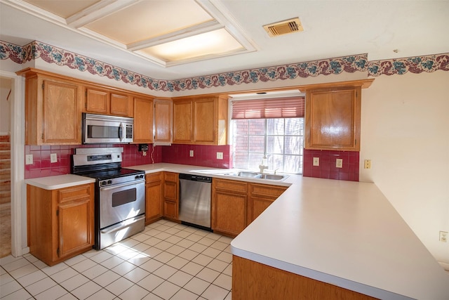 kitchen featuring decorative backsplash, light tile patterned floors, stainless steel appliances, and sink