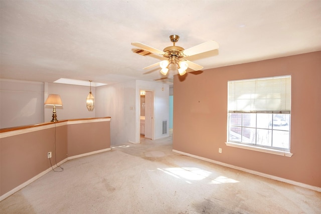 empty room with ceiling fan and light colored carpet