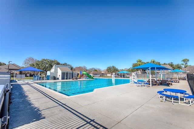 view of swimming pool featuring a patio area and an outdoor structure