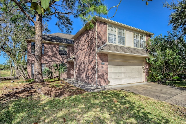 view of front of home featuring a front yard and a garage