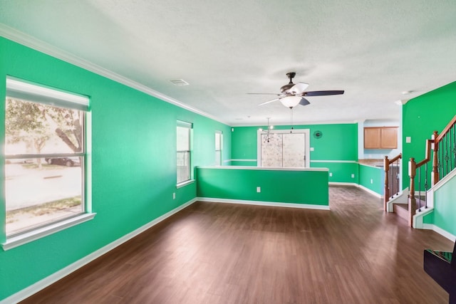 interior space featuring dark hardwood / wood-style floors, a wealth of natural light, and ornamental molding