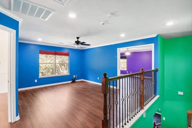 interior space featuring hardwood / wood-style flooring, ceiling fan, and crown molding