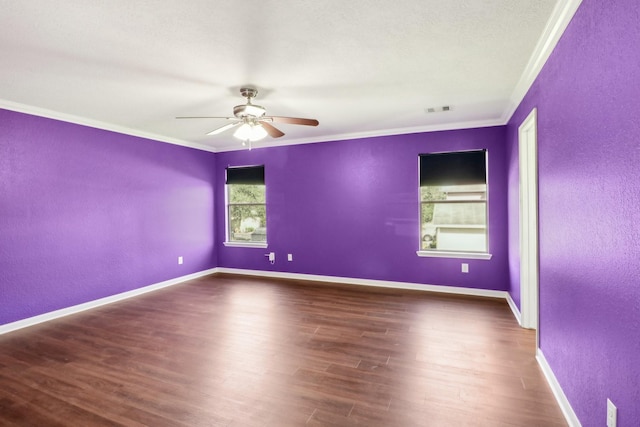 empty room with ceiling fan, dark hardwood / wood-style flooring, and crown molding