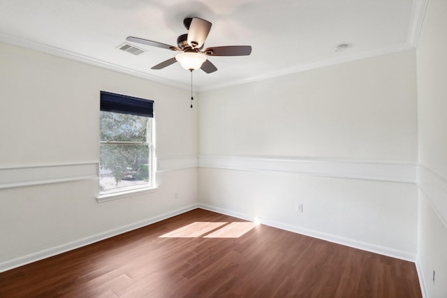 empty room featuring ceiling fan, dark hardwood / wood-style flooring, and ornamental molding