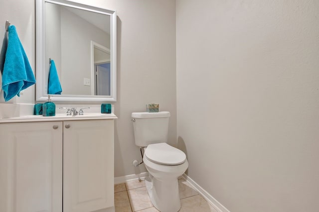 bathroom featuring tile patterned floors, vanity, and toilet