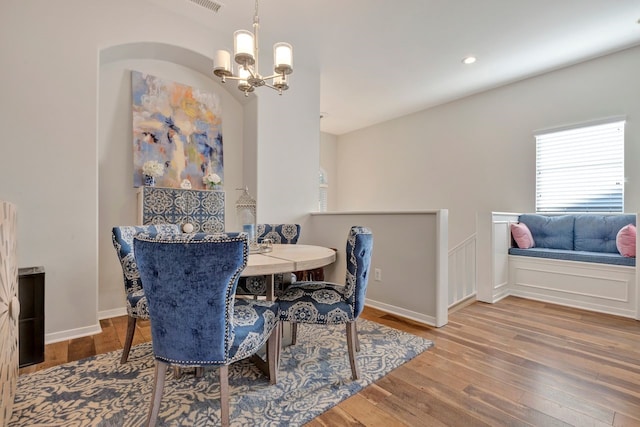 dining area featuring a notable chandelier and hardwood / wood-style flooring