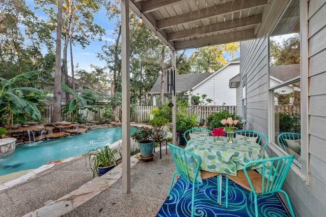 view of patio featuring a fenced in pool and pool water feature