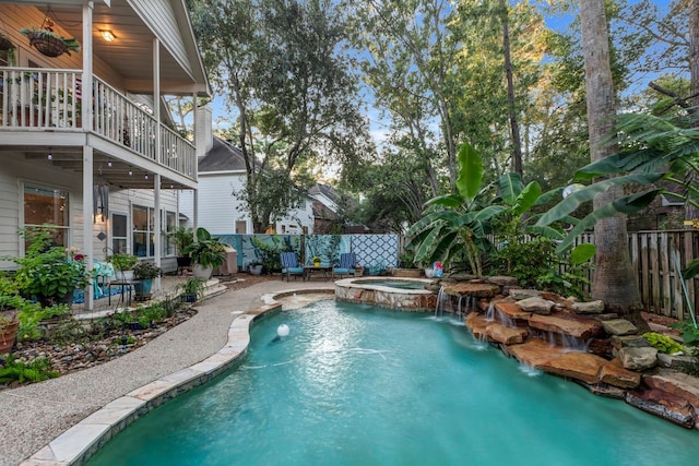 view of pool with an in ground hot tub and pool water feature