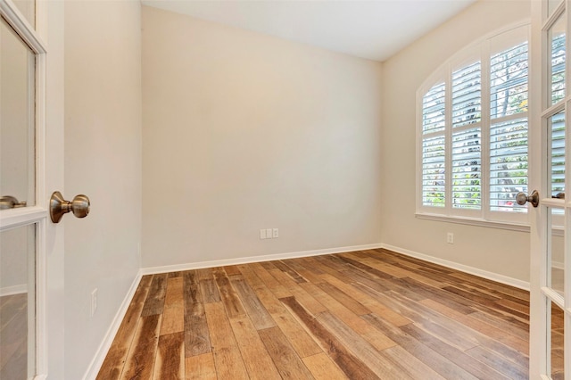 empty room featuring hardwood / wood-style flooring and a healthy amount of sunlight