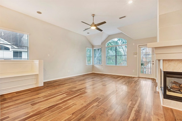 unfurnished living room featuring hardwood / wood-style floors, ceiling fan, and lofted ceiling