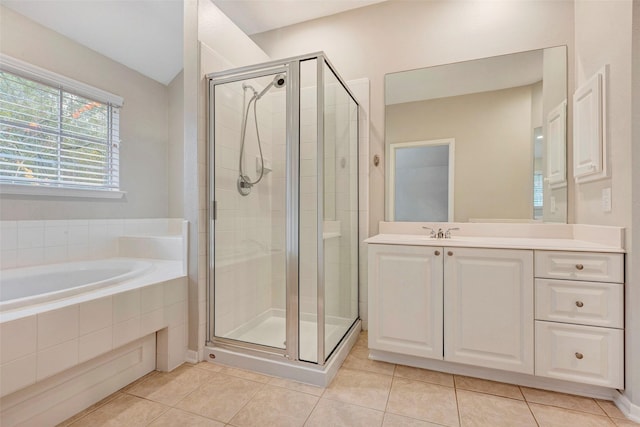 bathroom featuring tile patterned flooring, vanity, and separate shower and tub