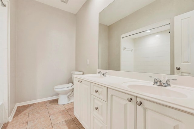 bathroom featuring a shower, tile patterned flooring, vanity, and toilet