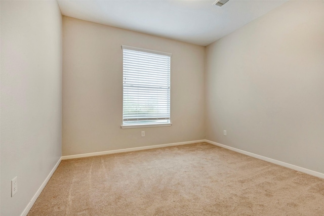 spare room with light colored carpet