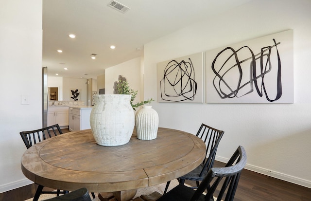 dining area featuring dark hardwood / wood-style flooring