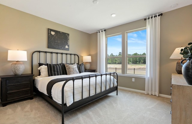 carpeted bedroom with multiple windows