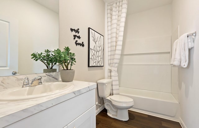 full bathroom with shower / bathing tub combination, vanity, wood-type flooring, and toilet