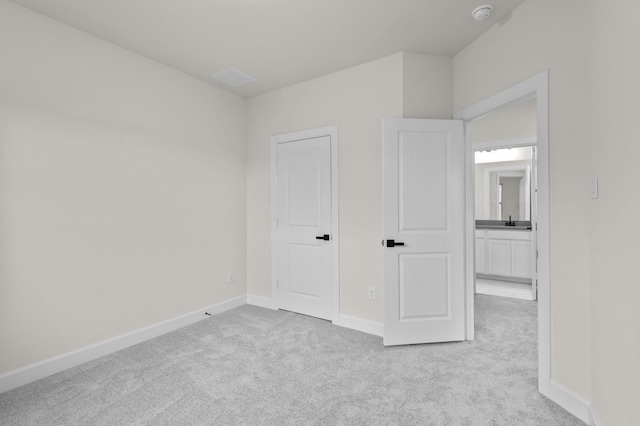 unfurnished bedroom featuring light carpet