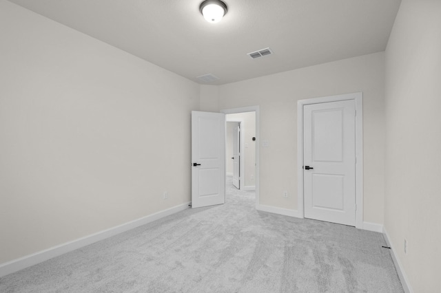 unfurnished bedroom featuring light colored carpet