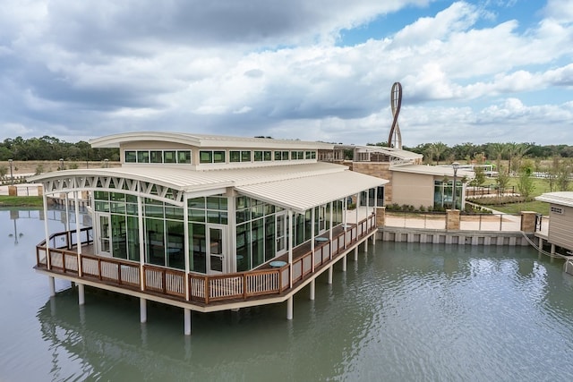 rear view of property with a water view