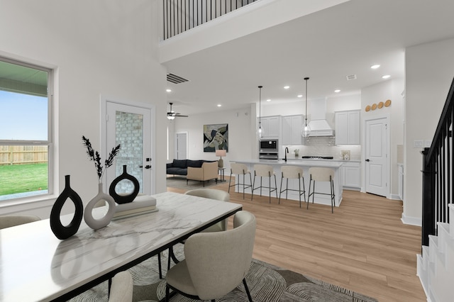 dining area featuring ceiling fan and light wood-type flooring