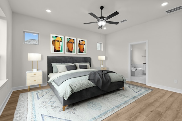 bedroom with connected bathroom, ceiling fan, and light hardwood / wood-style floors