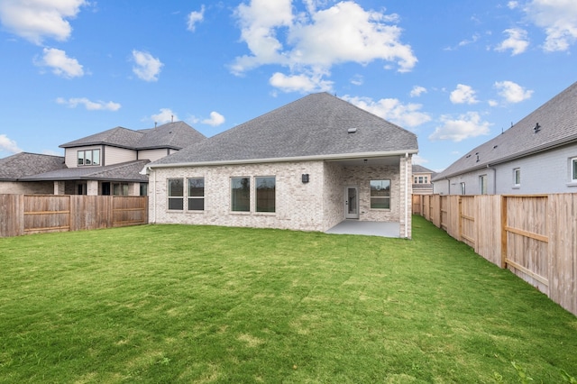 back of property with a patio area and a yard