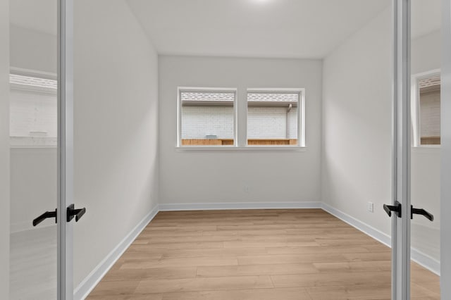 unfurnished room featuring plenty of natural light and light hardwood / wood-style floors