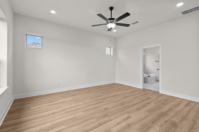 unfurnished room featuring light hardwood / wood-style floors, a wealth of natural light, and ceiling fan