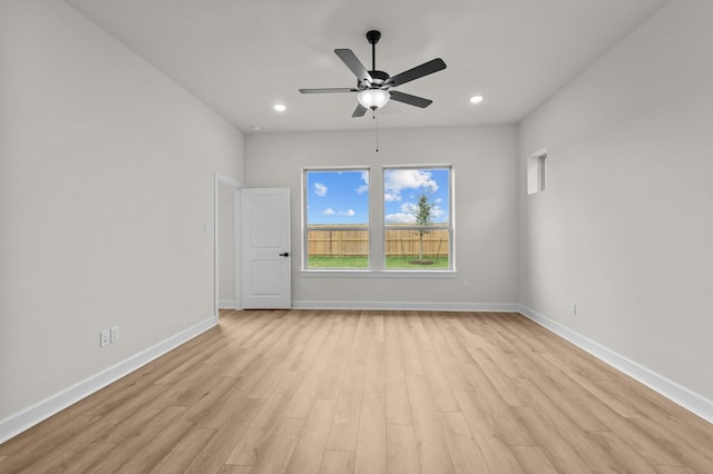 empty room featuring ceiling fan and light hardwood / wood-style flooring