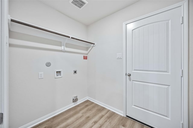 washroom with hookup for a washing machine, light hardwood / wood-style flooring, gas dryer hookup, and electric dryer hookup