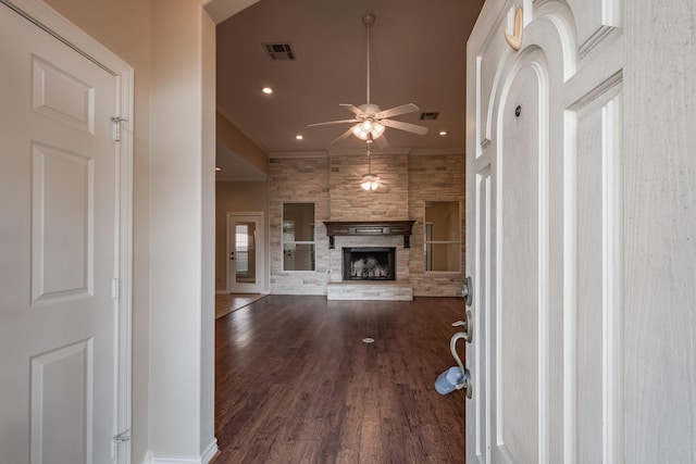 unfurnished living room with ceiling fan, a fireplace, dark hardwood / wood-style floors, and ornamental molding