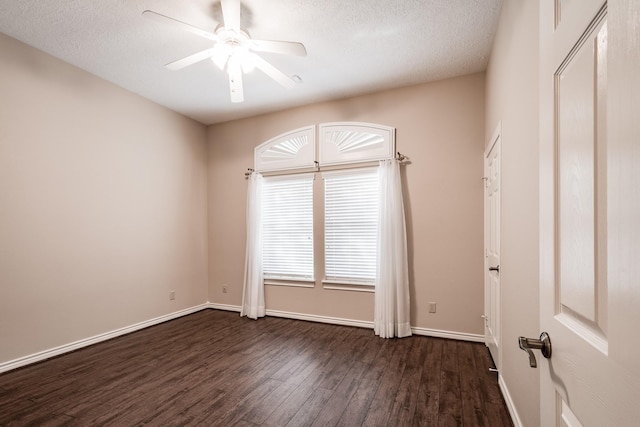 unfurnished room with a textured ceiling, dark hardwood / wood-style floors, and ceiling fan