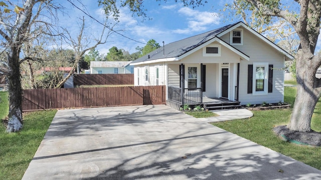 bungalow-style house with a porch and a front yard