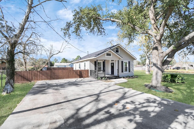 bungalow-style home with a porch and a front lawn