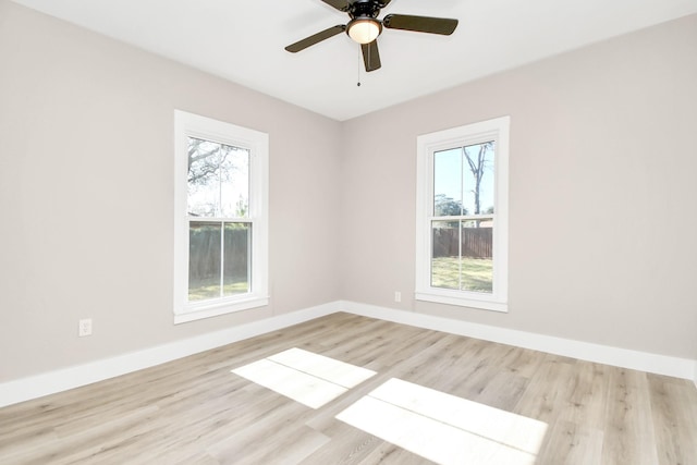 empty room with ceiling fan and light hardwood / wood-style flooring