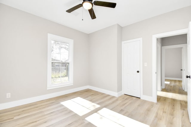 empty room with ceiling fan and light hardwood / wood-style floors